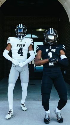 two football players standing in front of a tunnel