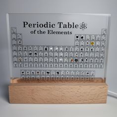 a wooden block with an image of the elements on it that says periodic table of the elements