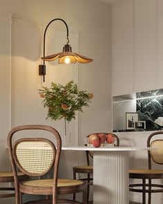 a dining room table with chairs and a potted plant