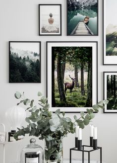 a table topped with pictures and candles next to a vase filled with flowers on top of it