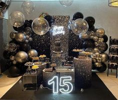 a black and silver party with balloons and decorations