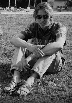 a woman sitting on the ground with her legs crossed