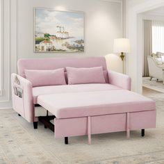 a living room with a pink couch and ottoman