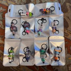 several pairs of scissors are on display in a pouch, with beads and keychains attached to the handles