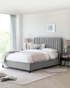 a bedroom with a large bed and white walls