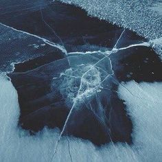 an aerial view of the ocean with ice and water