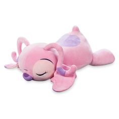 a pink stuffed animal laying on top of it's side with its eyes closed