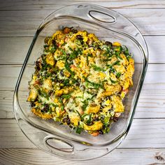 a glass casserole dish filled with vegetables and cheese