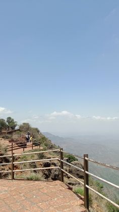 people are walking up the side of a hill