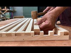 a person working with wood on a table