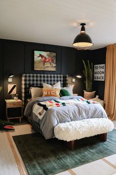 a bed room with a neatly made bed next to a green rug and potted plant