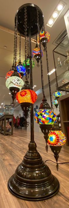 a chandelier with many colorful lights hanging from it's sides in a store