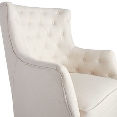 a white upholstered chair with buttons on the armrests and back rest