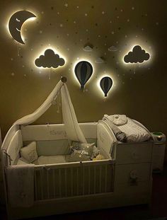 a baby's room with hot air balloons in the sky and stars on the wall