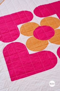 a pink and orange quilted with circles on it