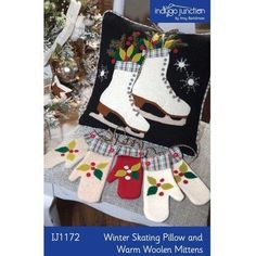 an image of christmas stockings and ice skates hanging from a pillow on a chair