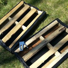 two wooden pallets sitting on top of grass