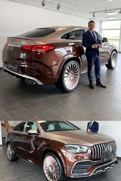 a man in a suit standing next to a brown mercedes suv with chrome rims