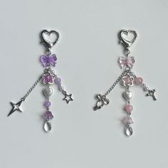 two pairs of dangling earrings with hearts, stars and charms attached to each earring