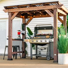 an outdoor bbq with grill, table and chairs