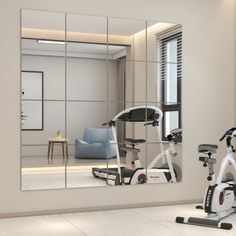 there is a gym with exercise equipment in the room and a mirror on the wall