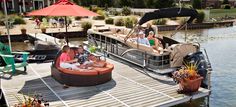 several people are sitting on a boat that is docked in the water with other boats