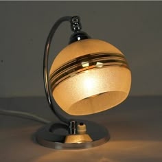 a lamp that is on top of a table with a light bulb in the middle