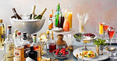 a table topped with lots of different types of food and drinks