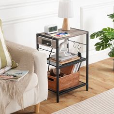 a living room with a couch, table and lamp on it's end table