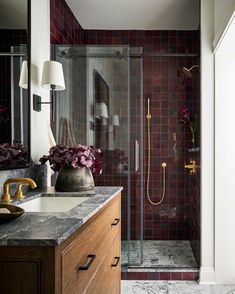 a bathroom with a sink, shower and mirror