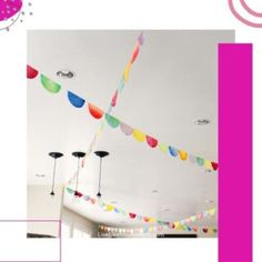 the ceiling is decorated with multicolored streamers and lights hanging from the ceiling