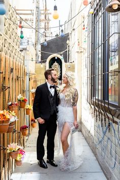 a man in a tuxedo standing next to a woman wearing a white dress