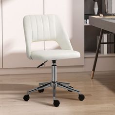 a white office chair sitting on top of a hard wood floor