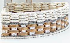 a close up of a woven basket on a white tablecloth with wood trimmings