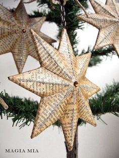 an ornament hanging from a christmas tree decorated with old newspaper pages and stars