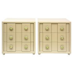 two white nightstands with gold knobs on each drawer and one has an open drawer