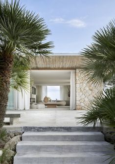 an open air living area with stairs leading to the bedroom