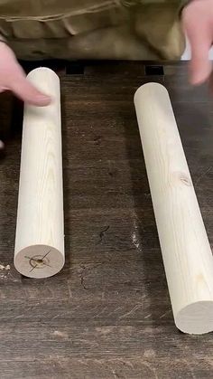 two pieces of wood sitting on top of a wooden table next to each other with one piece cut off