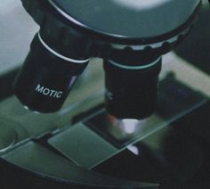 a close up view of a microscope with the word motc on it's side