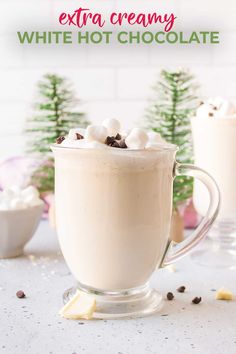 white hot chocolate in a glass mug topped with marshmallows