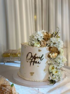 a wedding cake decorated with flowers and the word oppoul fau on it