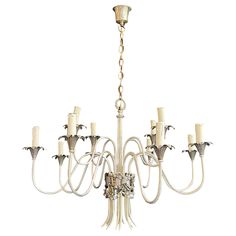 a white chandelier with twelve lights hanging from it's center and four arms