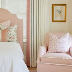 a bedroom with pink furniture and curtains