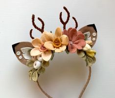 a headband with flowers and antlers on it