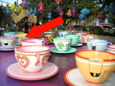 many colorful cups and saucers are sitting on a table