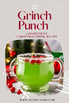 a green drink in a glass with christmas decorations around it and the words grinch punch on