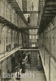 an old black and white photo of some people in a building with stairs to the second floor