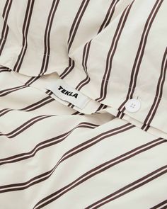 the label is on an unbuttoned shirt with black and white striped fabric