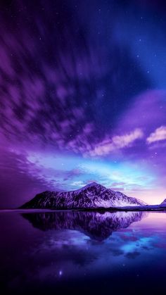 the sky is filled with purple and blue colors as it reflects in the still water