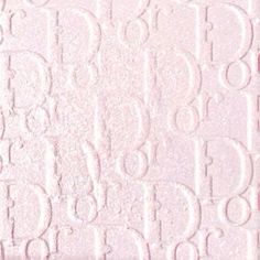 a close up view of the textured paper with letters and numbers in white on a light pink background